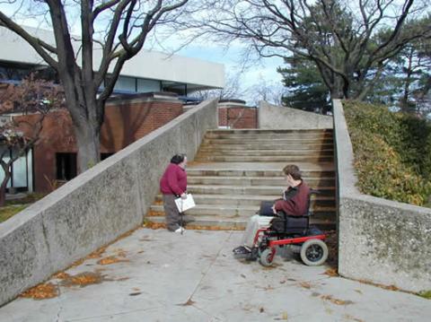 Proper signage could direct visitors to the no-step entry and spare people the frustration of having to backtrack. Chris O'Hanlon and Keith Ruff of the Evert Conner Center for Independent living survey the campus.