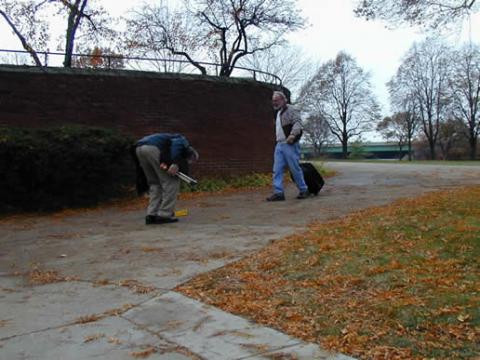 Professor Len Sandler and design specialist Jordan Pettus measure the slope, width and surface of a Coe College pathway.